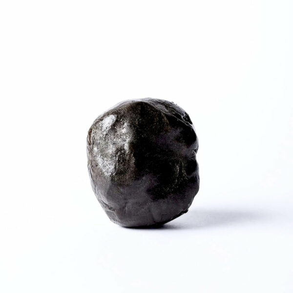 Close-up of traditional Moroccan hash showcasing its sticky consistency" "Moroccan hash crumbled on parchment paper ready for consumption" "Soft and pliable Moroccan hash highlighting its artisanal quality